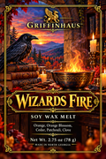 Front of a Griffinhaus 'Wizards Fire' soy wax melt package, featuring a fantasy illustration of a raven, burning brazier, candles, books, mountains, and autumn foliage. Text lists scent notes: Orange, Orange Blossom, Cedar, Patchouli, and Clove, with net weight 2.