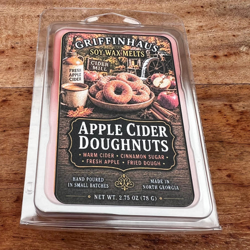 Griffenhaus Apple Cider Doughnuts soy wax melts in a clear plastic clamshell package, placed on a rustic wooden surface.
