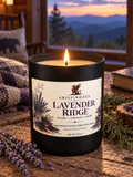 A lit black jar candle labeled Griffinhaus Lavender Ridge sits on a rustic wooden table with lavender sprigs, a knit blanket, and a mountain landscape window in the background.
