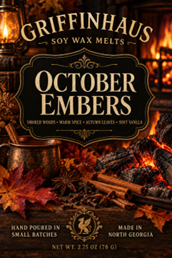 Front of a Griffenhaus 'October Embers' soy wax melt package, featuring a dark label with gold lettering over a warm autumnal scene with leaves, cinnamon sticks, and glowing embers.
